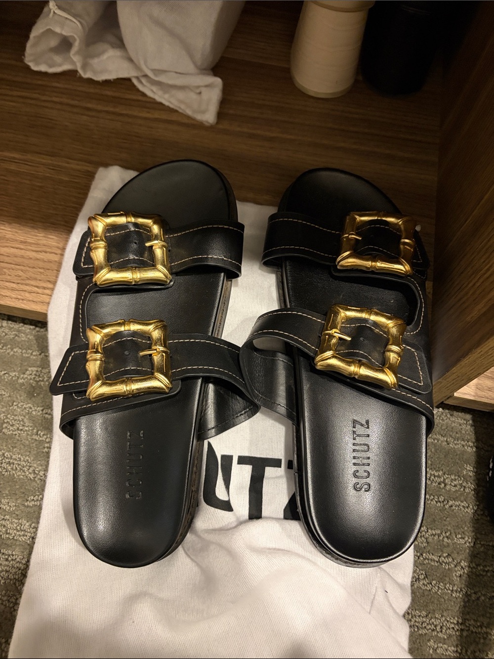 SCHUTZ Black Leather Slide Sandals with Gold Buckle Accents